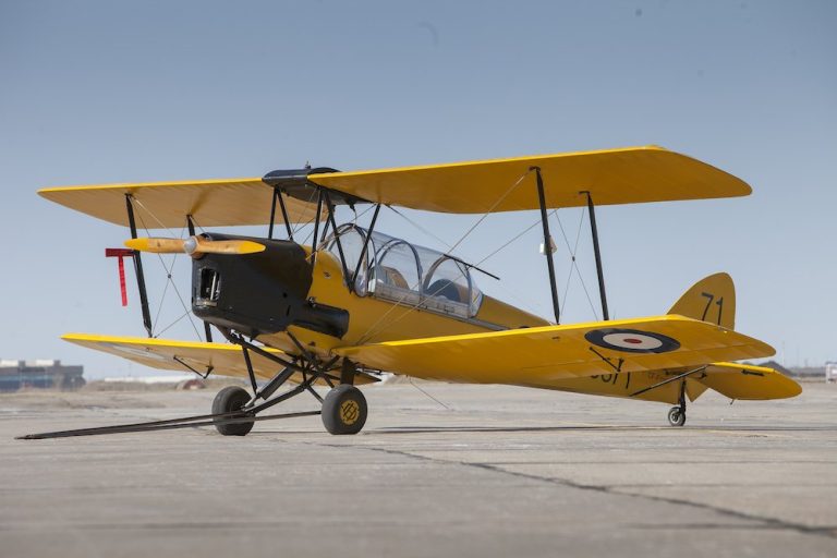 Yellow 1942 de Havilland Tiger Moth biplane on the apron