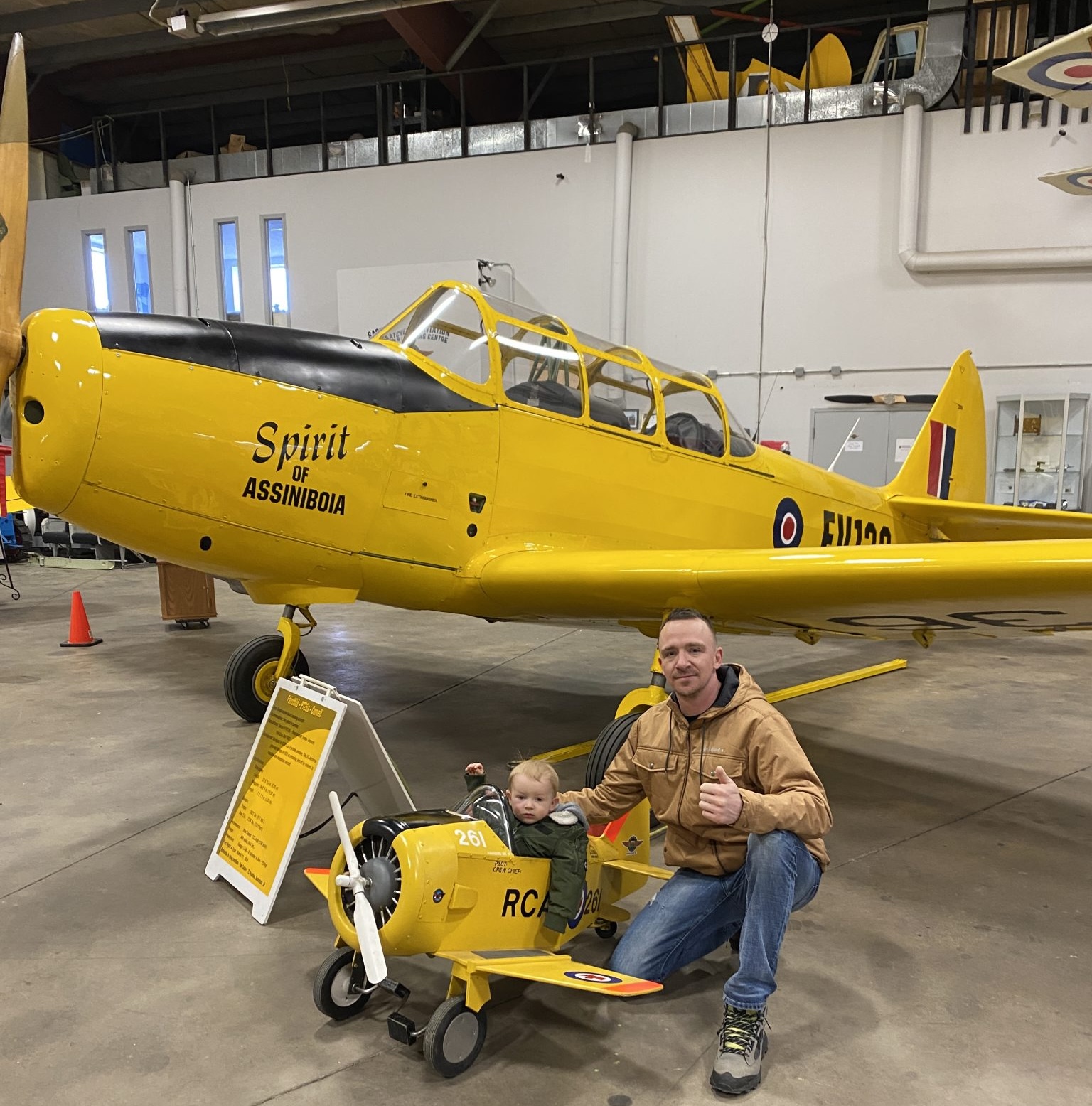 Yellow Harvard trainer on display inside the museum hangar